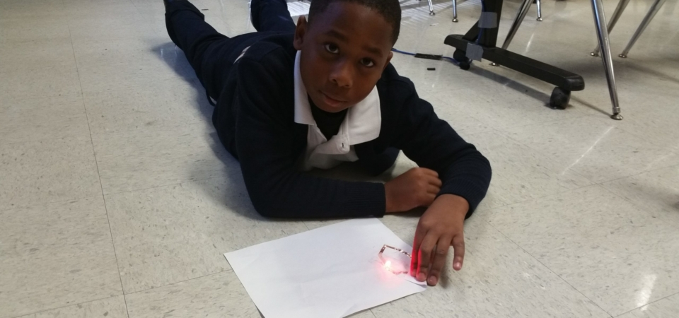 4th grader building simple circuit LED light