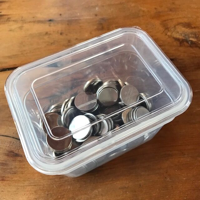 Store you dead batteries: Dead coin cell batteries in a plastic container