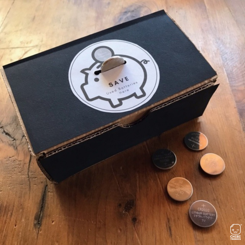 Store and save your dead batteries: Dead coin cell batteries in a cardboard box with logo