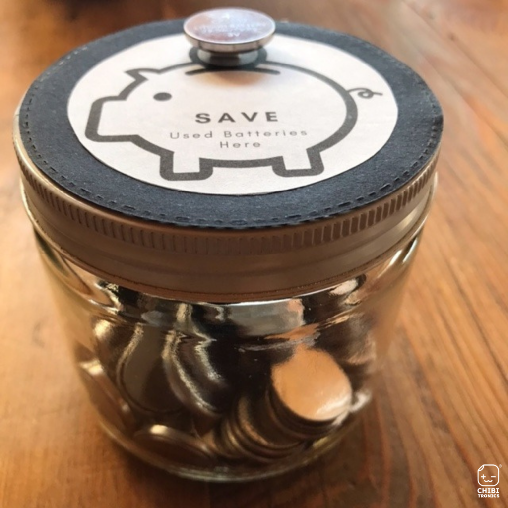 Store and save your dead batteries: Dead coin cell batteries in a glass jar with logo