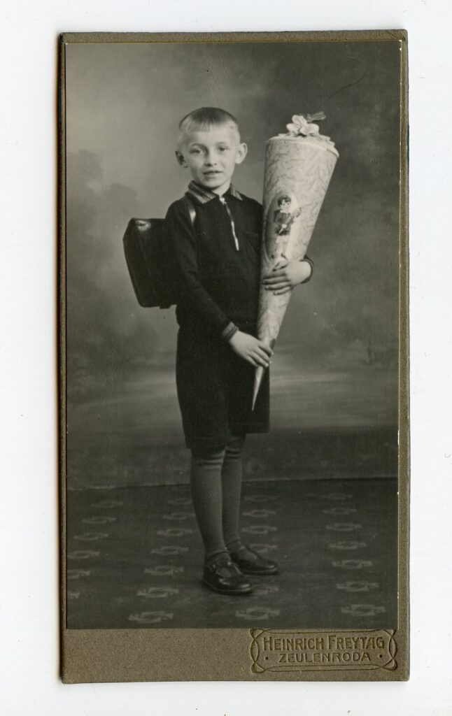 German boy holding a schultüte school cone