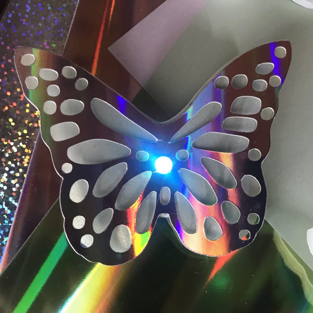 butterfly pin with an LED in the center 