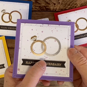A white gem animating LED blinks on and off as part of a wedding ring design on a card that reads " Happy Anniversary."