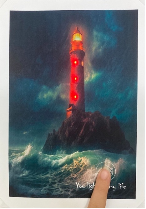 An illustration of a lighthouse has been placed over the circuit with the three red Sticker LEDs, lighting it up.