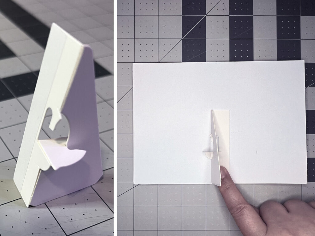 An adhesive triangular picture stand attached to the white backing board