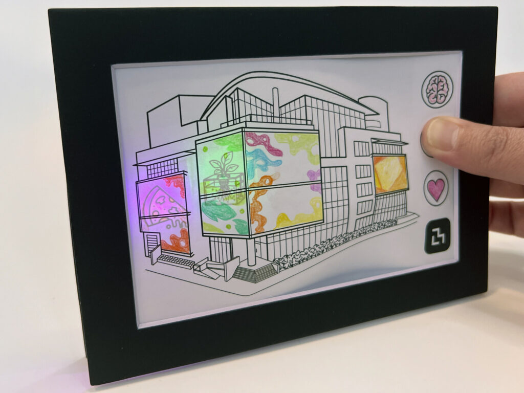 A framed Media Lab drawing with illuminated windows and hidden pictures